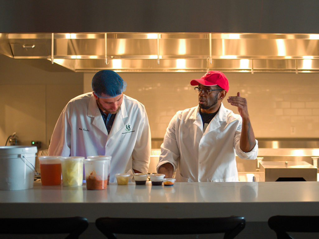 R&D employees collaborating in kitchen