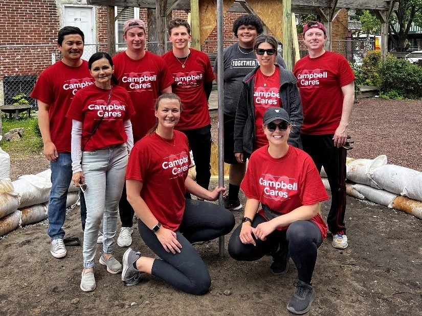 Employees pose in shed they're building