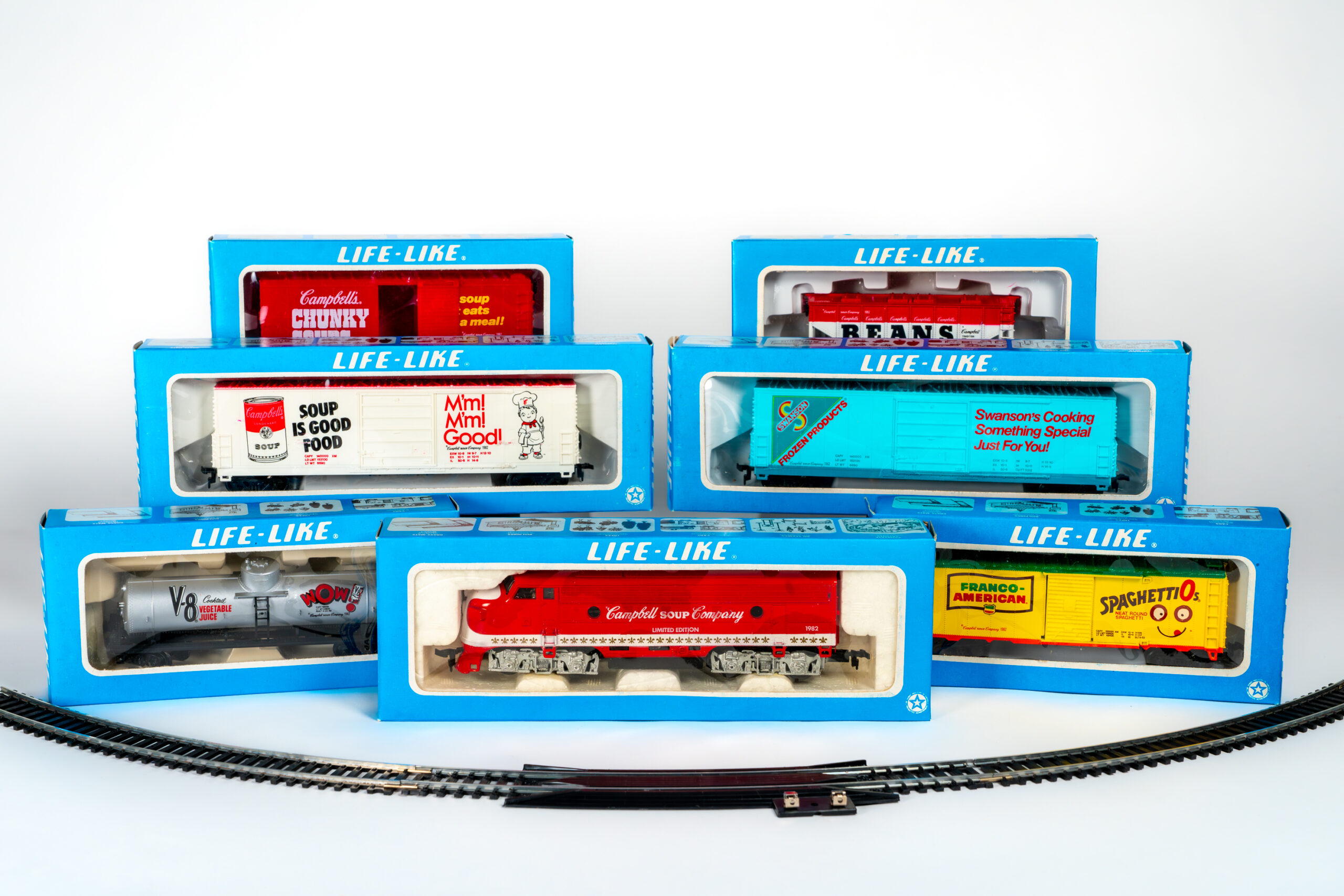 Toy train featuring Campbell’s, SpaghettiOs, V8 and Swanson in packaging with toy tracks.