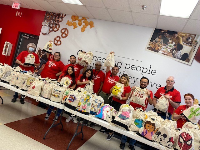 Goodyear employees posing with bags they packed for Campbell Cares
